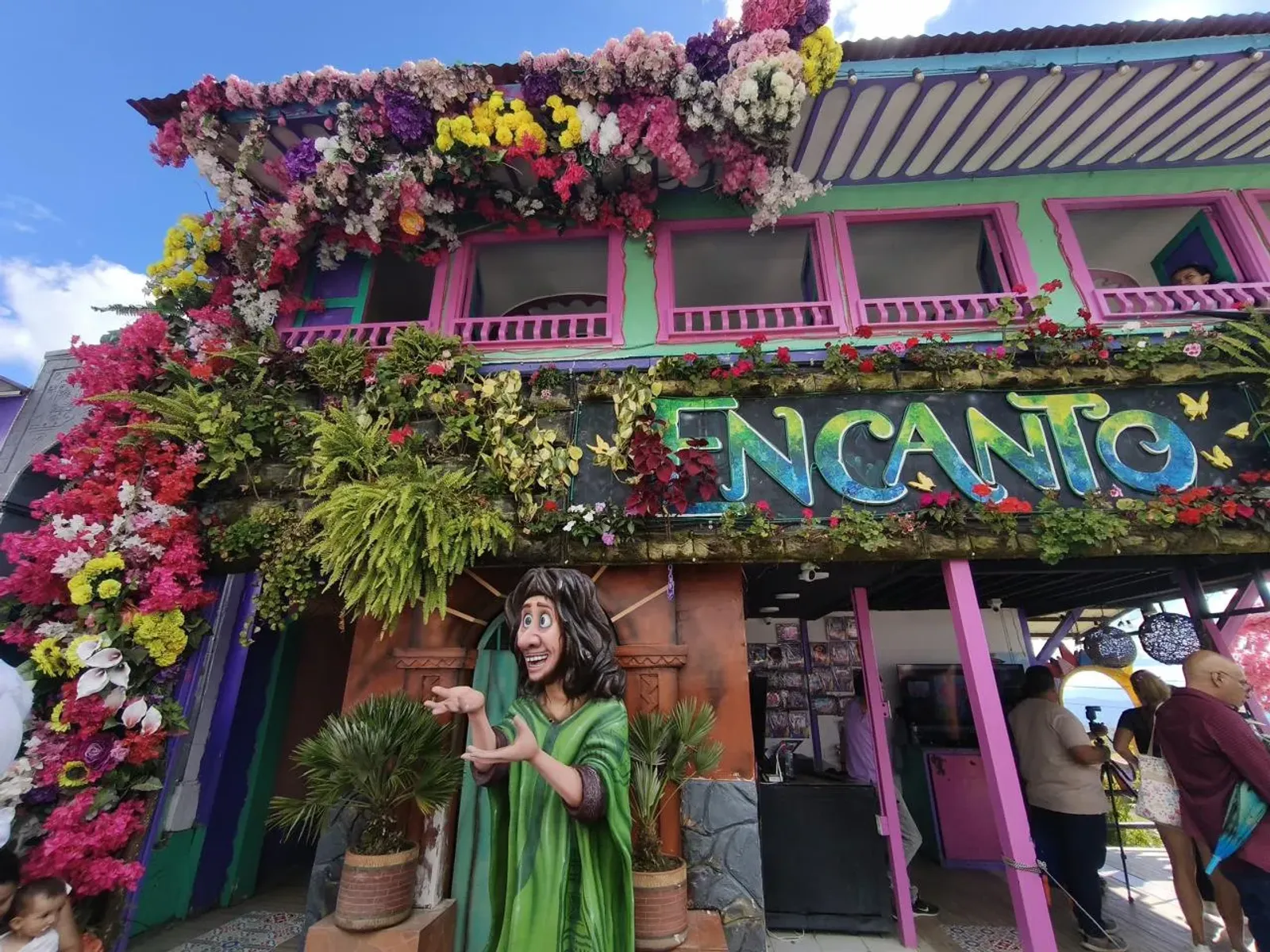 Fachada colorida con flores de la atracción temática Encanto, en el Parque del Café